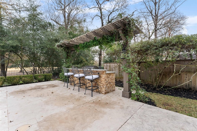 view of patio / terrace featuring a pergola and an outdoor bar