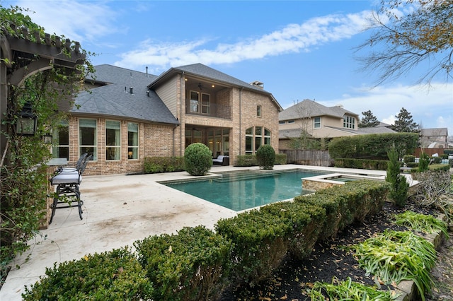 view of swimming pool with an in ground hot tub and a patio