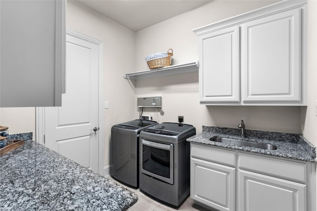 washroom with light tile patterned flooring, cabinets, separate washer and dryer, and sink