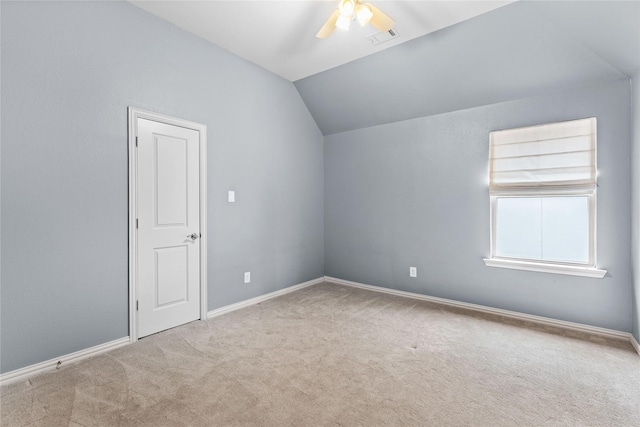 additional living space featuring vaulted ceiling, light carpet, and ceiling fan