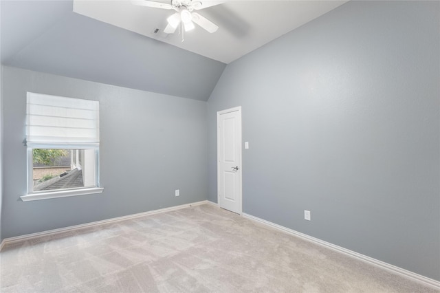 unfurnished room with lofted ceiling, light carpet, and ceiling fan