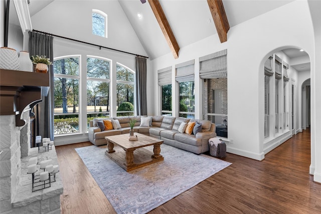 living room featuring beamed ceiling, dark hardwood / wood-style flooring, and high vaulted ceiling