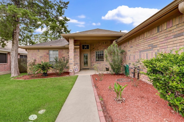 doorway to property featuring a yard