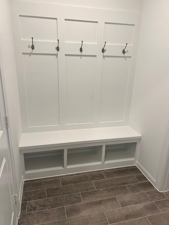 mudroom with baseboards and wood tiled floor