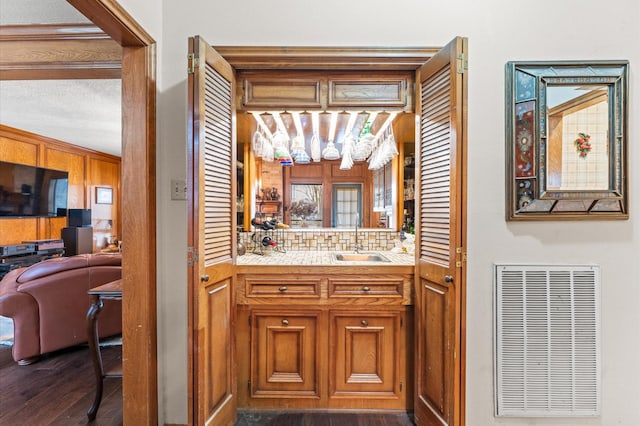 bathroom with tasteful backsplash, vanity, and wood-type flooring