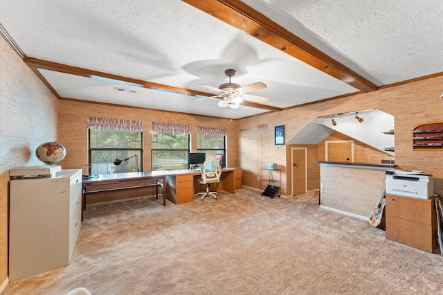 office space with ceiling fan, beamed ceiling, light colored carpet, and a textured ceiling