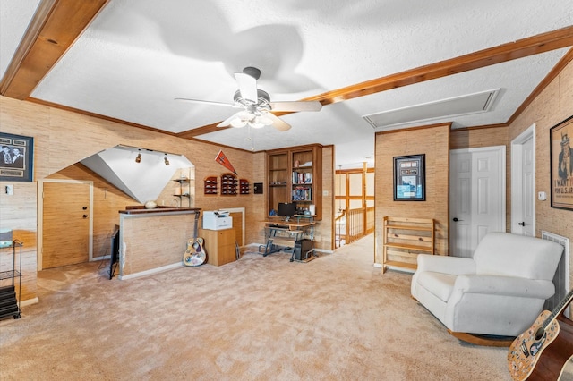 carpeted office space featuring ceiling fan, crown molding, and a textured ceiling