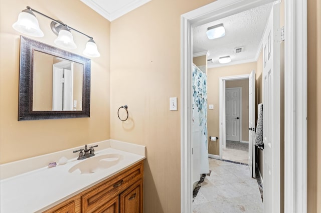 bathroom with crown molding, vanity, tile patterned flooring, and a textured ceiling