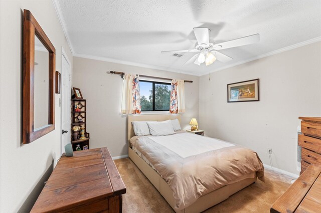 bedroom with crown molding, light colored carpet, ceiling fan, and a textured ceiling