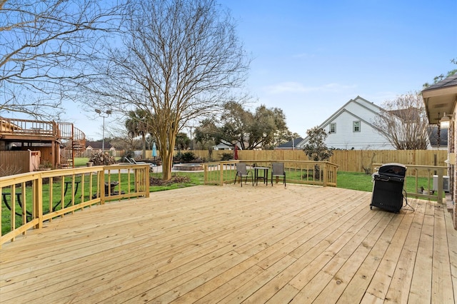 deck with cooling unit, area for grilling, and a lawn