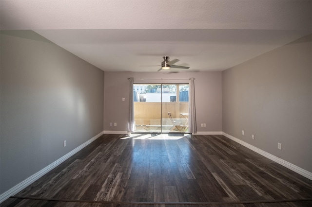 spare room with dark hardwood / wood-style floors and ceiling fan