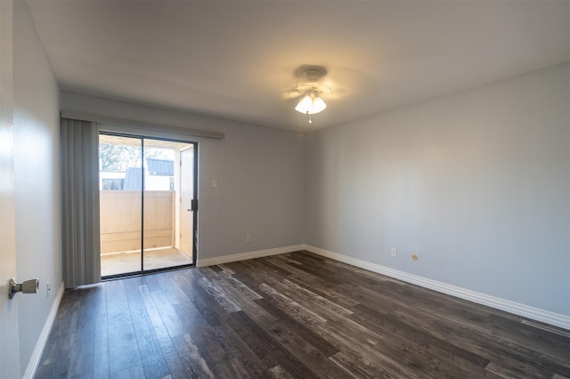 unfurnished room with dark wood-type flooring