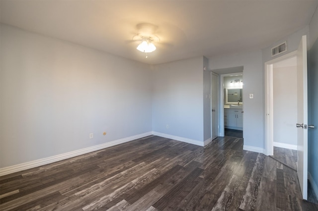 unfurnished room with dark hardwood / wood-style flooring