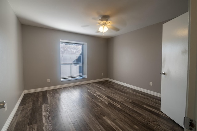 spare room with ceiling fan and dark hardwood / wood-style floors