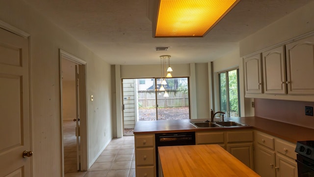 kitchen with sink, range, hanging light fixtures, kitchen peninsula, and black dishwasher