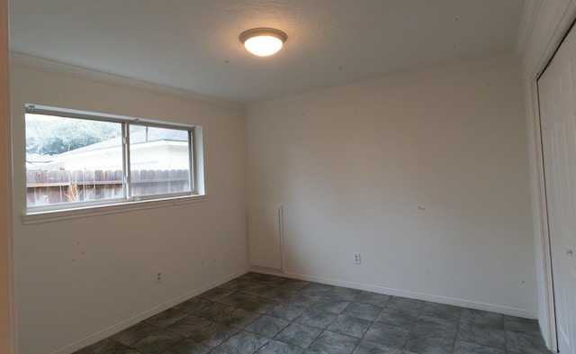 unfurnished room with crown molding