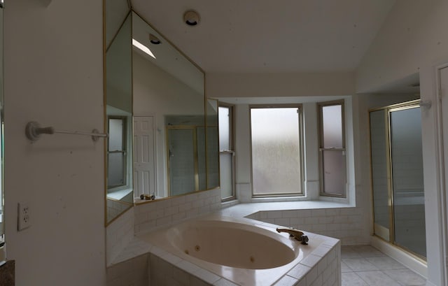 bathroom with tile patterned flooring, vaulted ceiling, and plus walk in shower