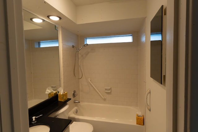 full bathroom with vanity, tiled shower / bath combo, and toilet