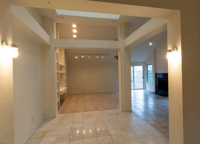 interior space with a skylight, a fireplace, and a high ceiling