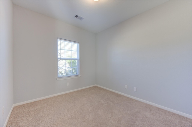 spare room featuring light colored carpet