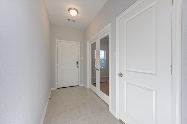 hall featuring light tile patterned flooring