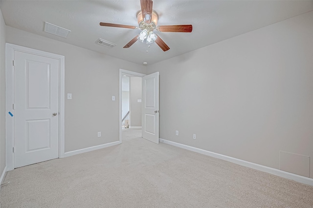 unfurnished bedroom with ceiling fan and light carpet