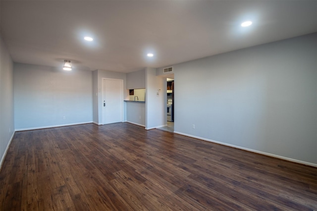 empty room with dark hardwood / wood-style floors