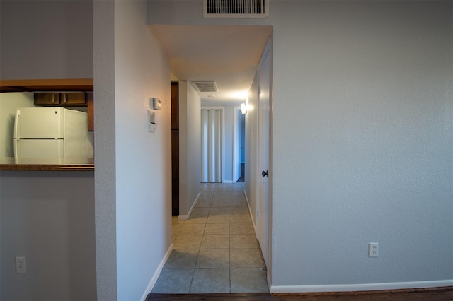 hall with light tile patterned flooring