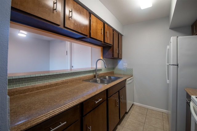 kitchen with white appliances, sink, decorative backsplash, and light tile patterned floors