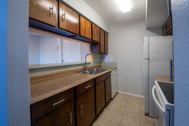 kitchen featuring backsplash, white appliances, sink, and light tile patterned floors