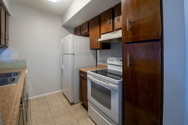 kitchen featuring tasteful backsplash, light tile patterned flooring, sink, and white appliances