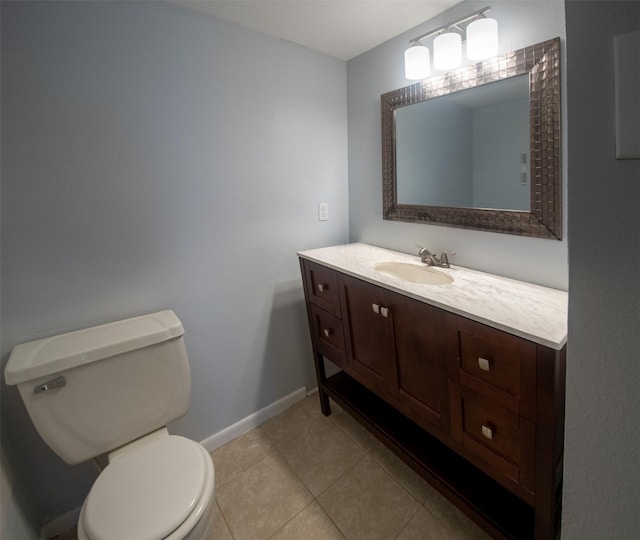 bathroom with tile patterned flooring, vanity, and toilet