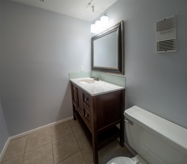 bathroom with vanity, track lighting, tile patterned floors, and toilet