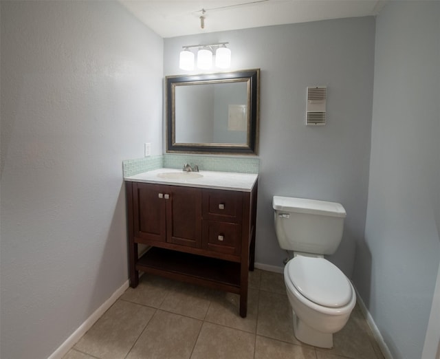 bathroom featuring tile patterned flooring, vanity, and toilet