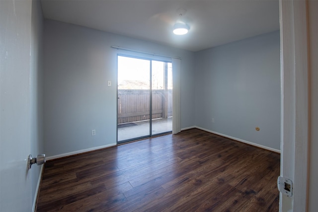 spare room with dark wood-type flooring