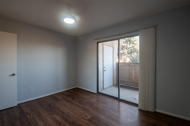 empty room featuring dark hardwood / wood-style flooring