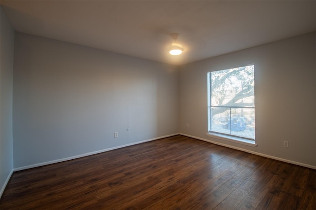 spare room with dark hardwood / wood-style flooring