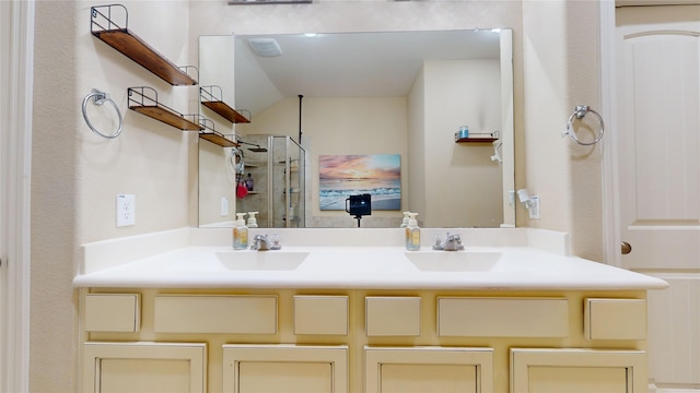 bathroom featuring vanity and an enclosed shower