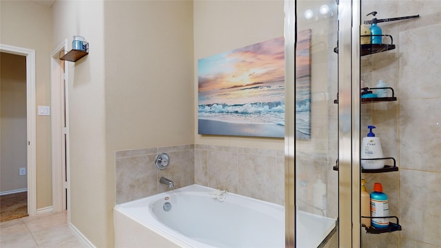 bathroom with tile patterned flooring and a tub