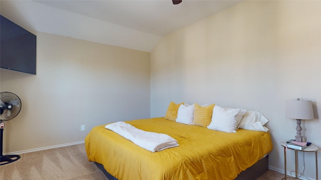 carpeted bedroom featuring lofted ceiling