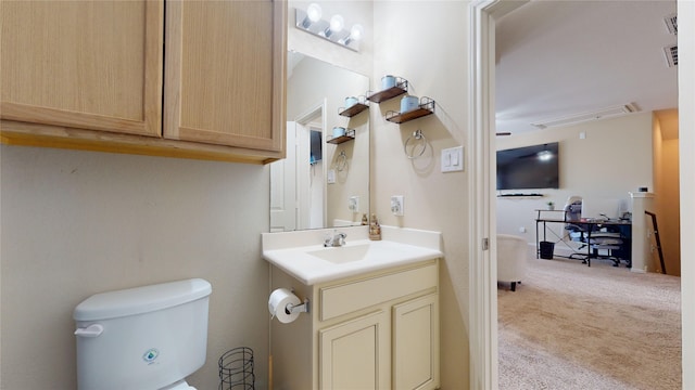 bathroom featuring vanity and toilet