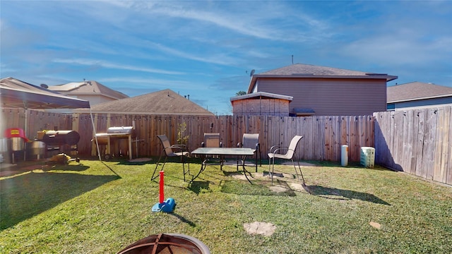 view of yard with an outdoor fire pit