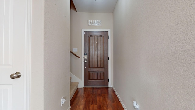 doorway with dark wood-type flooring