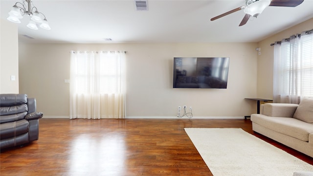 living room with dark wood-type flooring and ceiling fan