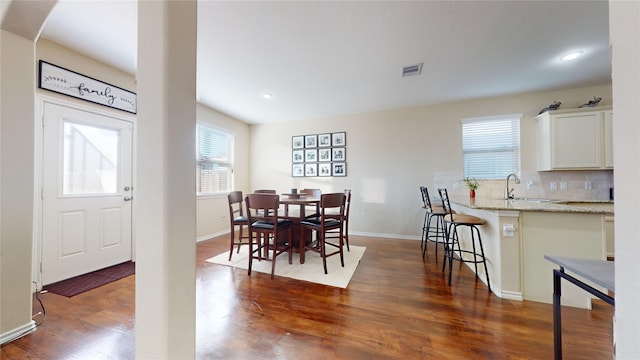 dining area with dark hardwood / wood-style flooring and sink