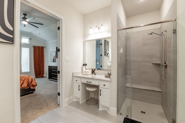 bathroom featuring ceiling fan, lofted ceiling, a shower with shower door, and vanity