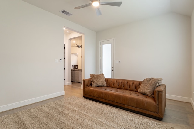 living room with ceiling fan, lofted ceiling, and hardwood / wood-style floors