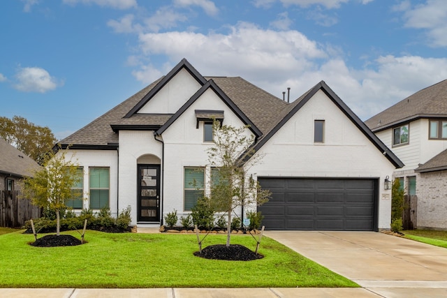 french country style house with a front lawn