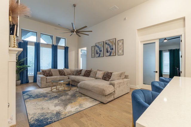 living room featuring ceiling fan, a healthy amount of sunlight, and light hardwood / wood-style floors