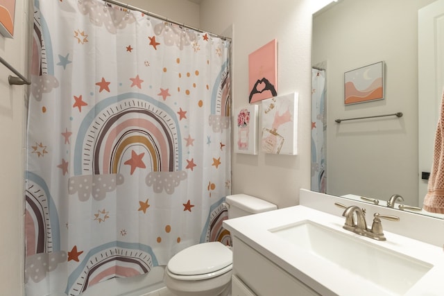 bathroom with vanity, a shower with shower curtain, and toilet